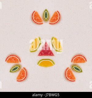 Mandala made from fruit made from marmalade. The pattern is on the gray table top. View from above Stock Photo