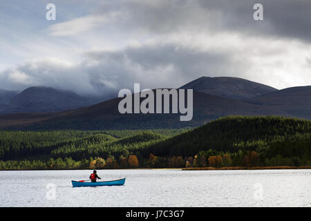 Man in a canoe on a lake in Scotland, UK. Stock Photo
