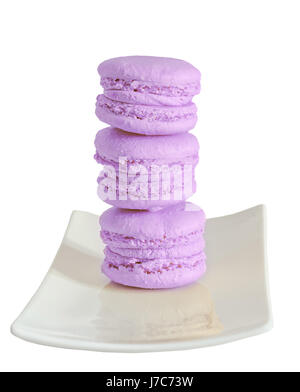 Violet sweet macaroons, french traditional, cream,  white plate, close up, isolated on a white background Stock Photo