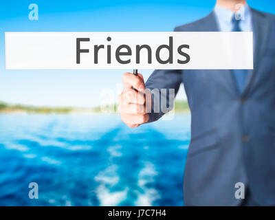 Friends - Businessman hand holding sign. Business, technology, internet concept. Stock Photo Stock Photo