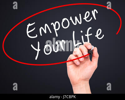 Man Hand writing Empower your Life with black marker on visual screen. Isolated on black. Life, technology, internet concept. Stock Image Stock Photo