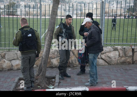 Israeli border police stop a Palestinian at a flying checkpoint in the Al Tur neighborhood of East Jerusalem, December 29, 2016. Stock Photo