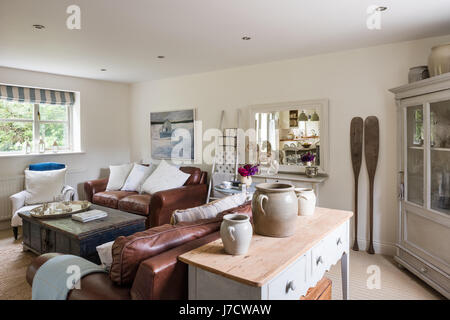 Laura Ashley leather sofas, Indian dowry chest and console table from Haus in airy sitting room Stock Photo