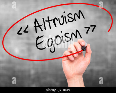 Man Hand writing Altruism - Egoism with black marker on visual screen. Isolated on background. Business, technology, internet concept. Stock Photo Stock Photo
