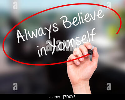 Man Hand writing Always Believe in Yourself with black marker on visual screen. Isolated on background. Business, technology, internet concept. Stock  Stock Photo