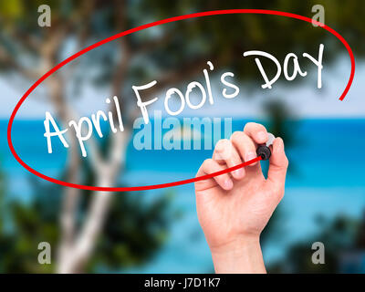 Man Hand writing April Fool's Day with black marker on visual screen. Isolated on nature. Business, technology, internet concept. Stock Photo Stock Photo
