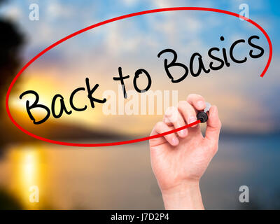 Man Hand writing Back to Basics with black marker on visual screen. Isolated on nature. Business, technology, internet concept. Stock Photo Stock Photo