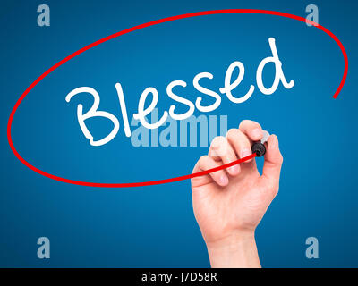 Man Hand writing Blessed with black marker on visual screen. Isolated on blue. Business, technology, internet concept. Stock Photo Stock Photo