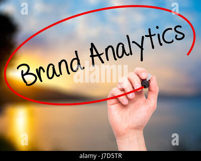 Man Hand writing Brand Analytics with black marker on visual screen. Isolated on background. Business, technology, internet concept. Stock Photo Stock Photo