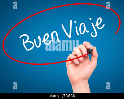 Man Hand writing Buen Viaje (Good Trip in Spanish) with black marker on visual screen. Isolated on blue. Business, technology, internet concept. Stock Stock Photo
