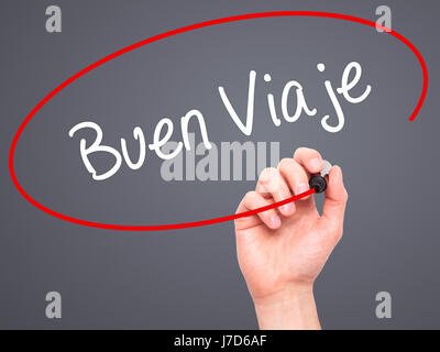 Man Hand writing Buen Viaje (Good Trip in Spanish) with black marker on visual screen. Isolated on grey. Business, technology, internet concept. Stock Stock Photo