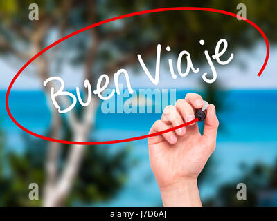 Man Hand writing Buen Viaje (Good Trip in Spanish) with black marker on visual screen. Isolated on nature. Business, technology, internet concept. Sto Stock Photo