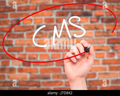 Man Hand writing CMS (Custom Management System) with black marker on visual screen. Isolated on background. Business, technology, internet concept. St Stock Photo