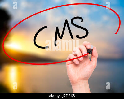 Man Hand writing CMS (Custom Management System) with black marker on visual screen. Isolated on background. Business, technology, internet concept. St Stock Photo
