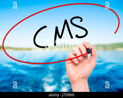 Man Hand writing CMS (Custom Management System) with black marker on visual screen. Isolated on background. Business, technology, internet concept. St Stock Photo