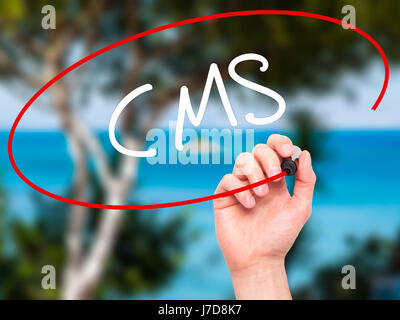 Man Hand writing CMS (Custom Management System) with black marker on visual screen. Isolated on background. Business, technology, internet concept. St Stock Photo