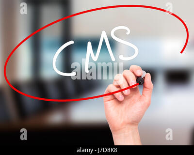 Man Hand writing CMS (Custom Management System) with black marker on visual screen. Isolated on background. Business, technology, internet concept. St Stock Photo
