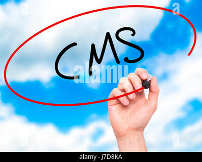 Man Hand writing CMS (Custom Management System) with black marker on visual screen. Isolated on background. Business, technology, internet concept. St Stock Photo