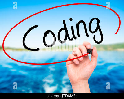 Man Hand writing Coding with black marker on visual screen. Isolated on background. Business, technology, internet concept. Stock Photo Stock Photo