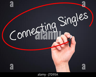 Man Hand writing Connecting Singles with black marker on visual screen. Isolated on black. Business, technology, internet concept. Stock Photo Stock Photo