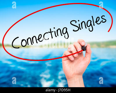 Man Hand writing Connecting Singles with black marker on visual screen. Isolated on nature. Business, technology, internet concept. Stock Photo Stock Photo