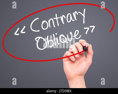 Man Hand writing Contrary - Oblique with black marker on visual screen. Isolated on background. Business, technology, internet concept. Stock Photo Stock Photo
