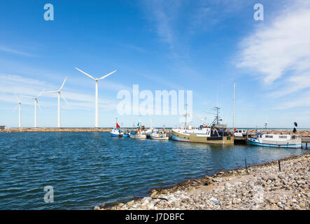 Bonnerup Strand, Denmark - May 4, 2017: The small fishery harbor at Bonnerup on the Baltic Sea coast with wind turbines on the pier Stock Photo