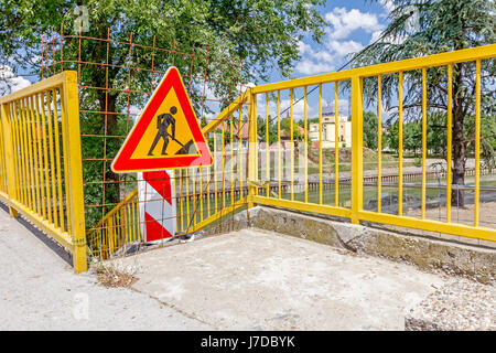 Closed enter at construction zone, work in progress, sign with boundary are symbols of caution, road resurfacing signal. Stock Photo