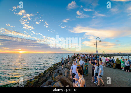 Melbourne, Australia - December 28, 2016: Crowd of people gathered at St Kilda breakwater to watch penguins after sunset on a warm summer evening Stock Photo