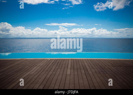 Dominican Republic infinity pool with view to the ocean on lightly cloudy day Stock Photo