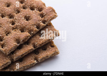 Close up shot of the heap of crisp bread on white paper background. Copy space for any information. Stock Photo