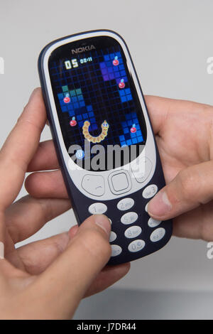 A person plays the classic mobile game Snake as the new Nokia 3310