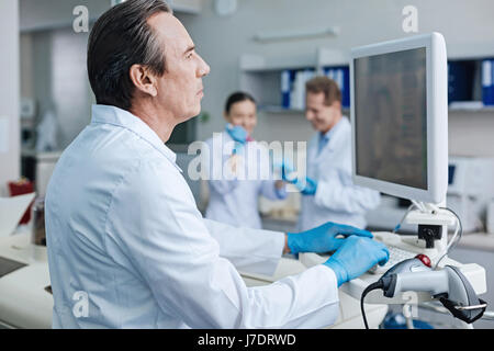 Confident practitioner working with computer Stock Photo