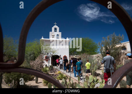 Tucson, Arizona - Visitors enter a chapel at Mission San Xavier del Bac on the Tohono O'odham Nation. The mission was established the Spanish in 1692; Stock Photo
