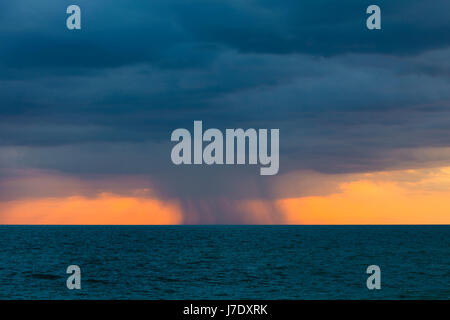Rain storm over the Gulf of Mexico at sunset on the west coast of Florida Stock Photo