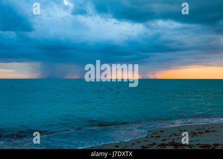 Rain storms over the Gulf of Mexico at sunset on the west coast of Florida Stock Photo