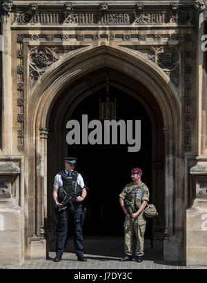 Members of the army join police officers in Westminster, London, after Scotland Yard announced armed troops will be deployed to guard 'key locations' such as Buckingham Palace, Downing Street, the Palace of Westminster and embassies. Stock Photo
