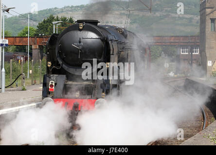 Merchant Navy class steam locomotive British India Line in black livery approaching Carnforth station as it prepares to do a test run to Hellifield. Stock Photo