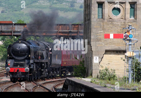 Merchant Navy class steam locomotive British India Line in black livery leaving Carnforth station as it sets off on a test run to Hellifield. Stock Photo