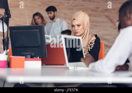 Arabic business woman wearing hijab,working in startup office. Stock Photo