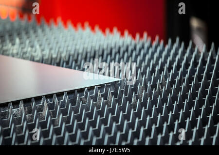 Metal sheet on laser cutting machine table Stock Photo