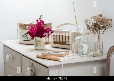 Roberts radio and glass bell jars on upcycled chest of drawers painted in Annie Sloan's Old White and Country Grey Stock Photo