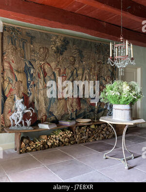 17th century Flemish tapestry 'Triumph of Diana' with cafe table and French mid-19th century glass chandelier Stock Photo