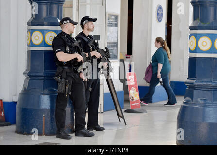 Brighton, UK. 24th May, 2017.  Armed police on the concourse of Brighton Railway Station this evening at rush hour as part of heightened security throughout Britain due to the Manchester terrorist attack  Credit: Simon Dack/Alamy Live News Stock Photo