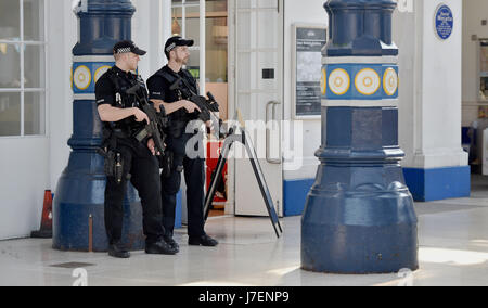 Brighton, UK. 24th May, 2017.  Armed police on the concourse of Brighton Railway Station this evening at rush hour as part of heightened security throughout Britain due to the Manchester terrorist attack  Credit: Simon Dack/Alamy Live News Stock Photo