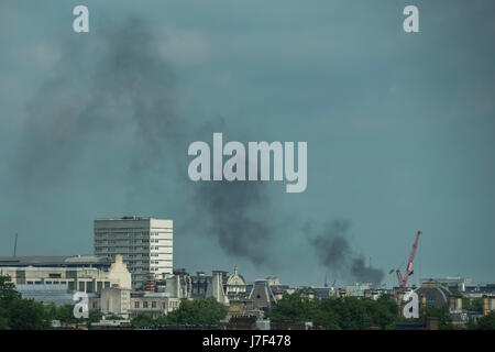 London, UK. 25th May, 2017. Smoke rising from a building site fire in Kings Cross raises concern amongst people in the Peter Jones cafe, fearing that it might be a terrorist incident. Nerves are on edge at any sign of something out of the ordinary. London 25 May 2017. Credit: Guy Bell/Alamy Live News Stock Photo