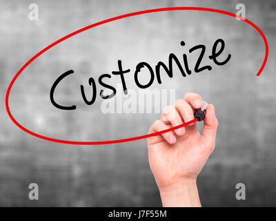 Man Hand writing  Customize with black marker on visual screen. Isolated on grey. Business, technology, internet concept. Stock Photo Stock Photo
