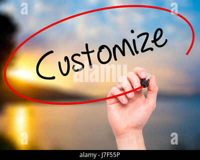 Man Hand writing  Customize with black marker on visual screen. Isolated on nature. Business, technology, internet concept. Stock Photo Stock Photo