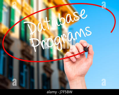 Man Hand writing Database Programs with black marker on visual screen. Isolated on background. Business, technology, internet concept. Stock Photo Stock Photo
