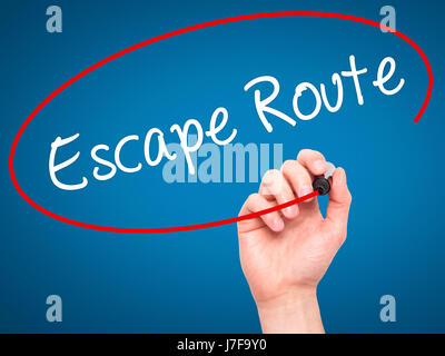 Man Hand writing Escape Route with black marker on visual screen. Isolated on blue. Business, technology, internet concept. Stock Photo Stock Photo